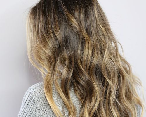 Back of woman with wavy, highlighted hair