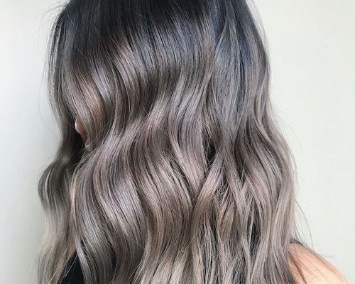 Side view of curled hair with silver-toned balayage