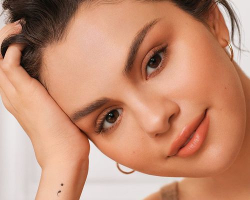 Selena Gomez with a fresh makeup look and semicolon tattoo on wrist