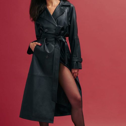 Reformation Veda Ashland Leather Trench in black on model wearing sheer tights