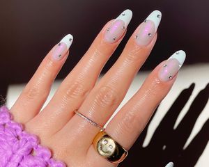 French manicure with iridescent base, white tips, and rhinestone studs