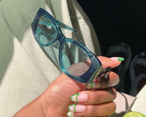 Blue tinted sunglasses and green double French tip manicure