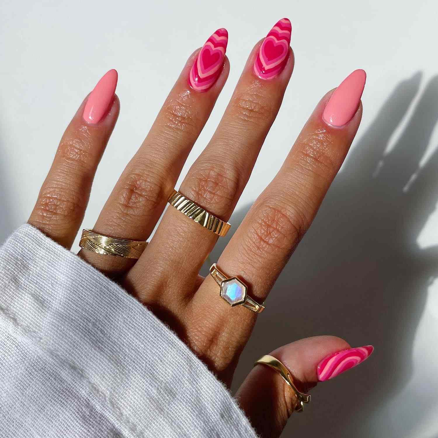 Pink manicure with radiating heart-shaped accent nails