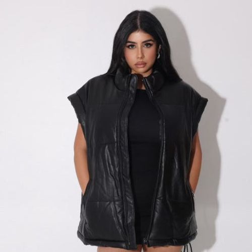 Model wearing the black Invested Puffer Vest by Nichole Lynel