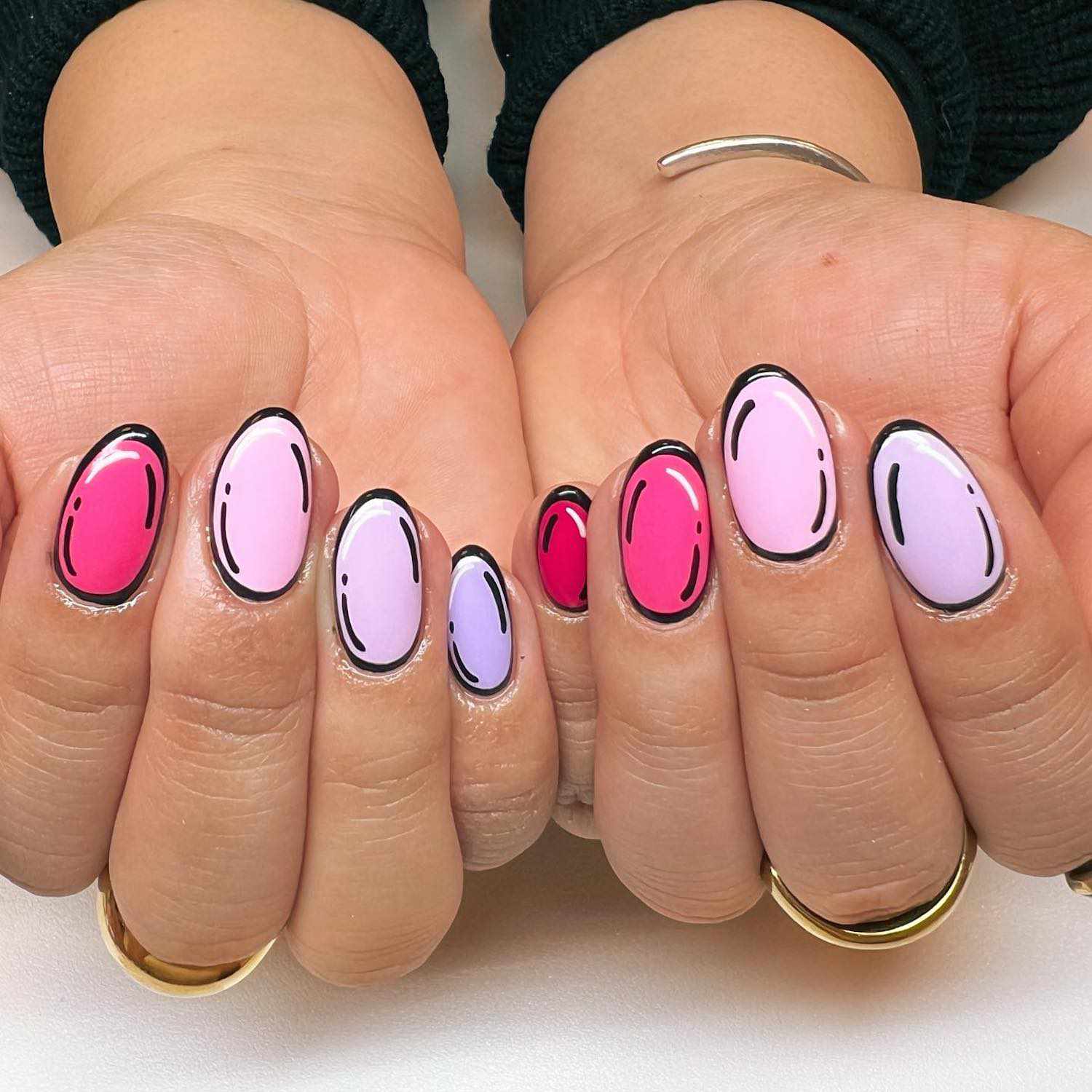 Fuchsia, hot pink, pale pink, and lavender nails with pop art accents