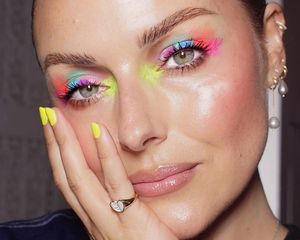 Makeup artist Katie Jane Hughes wears a neon watercolor splatter paint-inspired eye makeup look