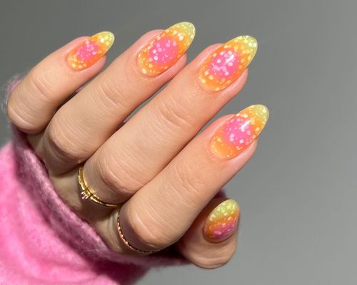 Manicure with pink and yellow ombre aura base and confetti texture