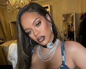 Close up of Rihanna with black-lined lips and silvery smoky eyes