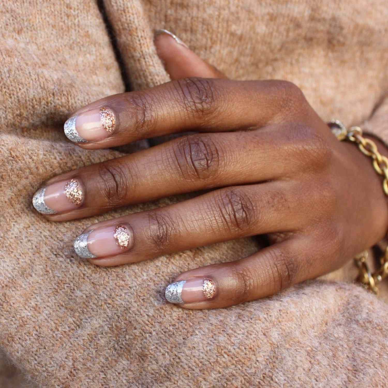 Glitter manicure with silver French tips and rose gold cuticle half-moons