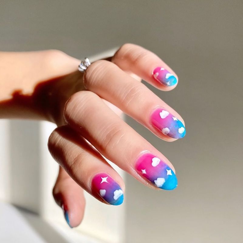 Pink to blue neon ombre nails with puffy white cloud nail art