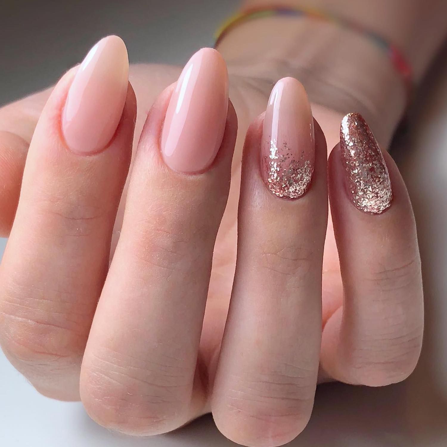 Baby pink manicure with rose gold glitter accent nails