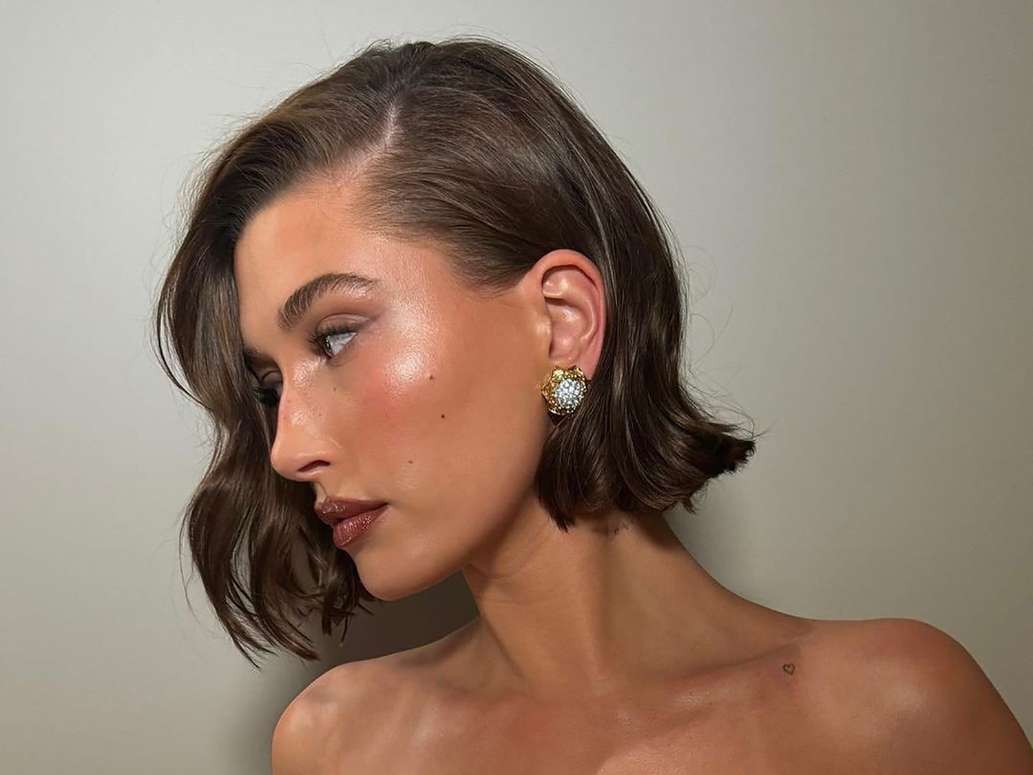 Hailey Bieber with a chin-length bob haircut, viewed in profile