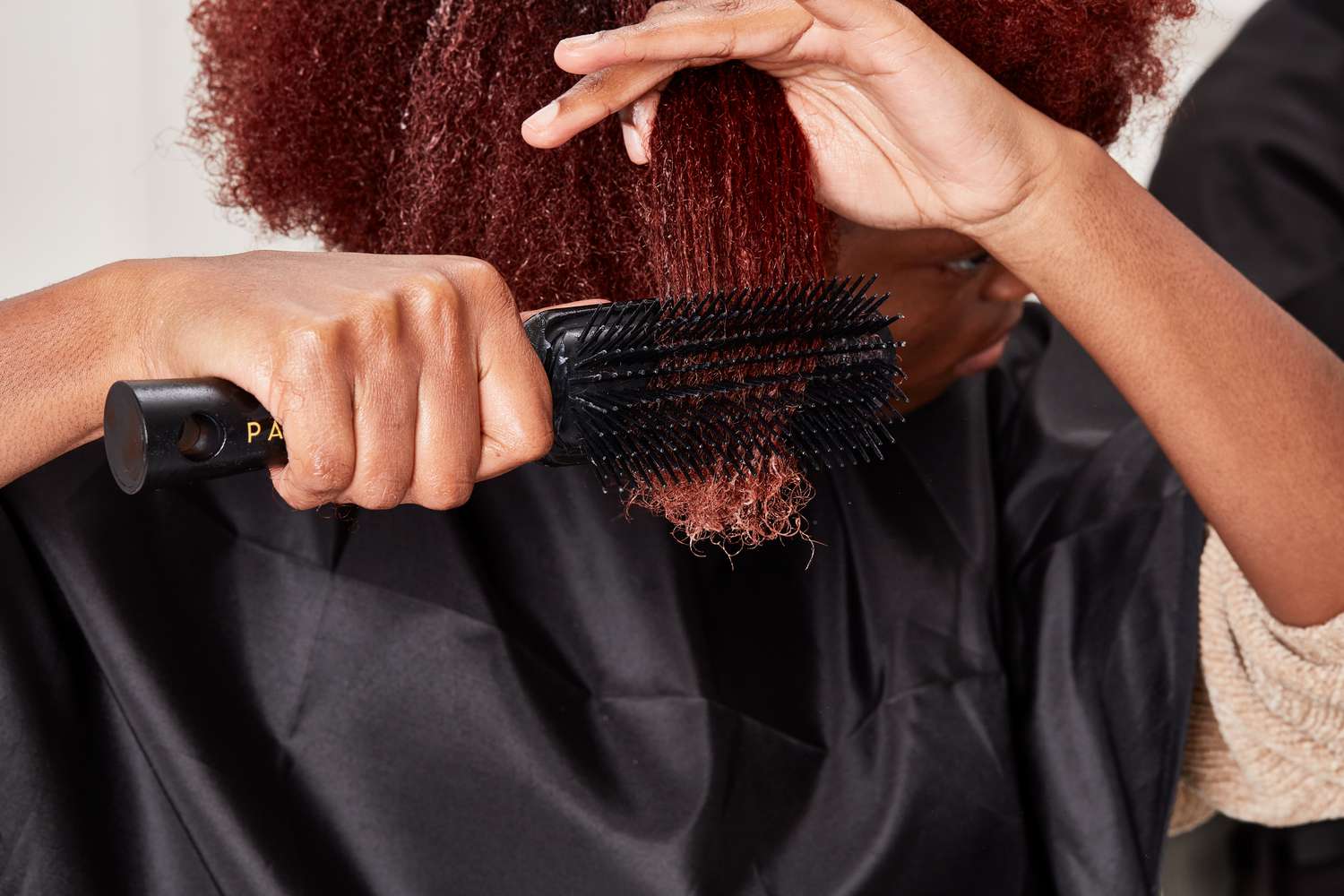 Person brushing hair with Pattern by Tracee Ellis Ross Shower Detangling Brush