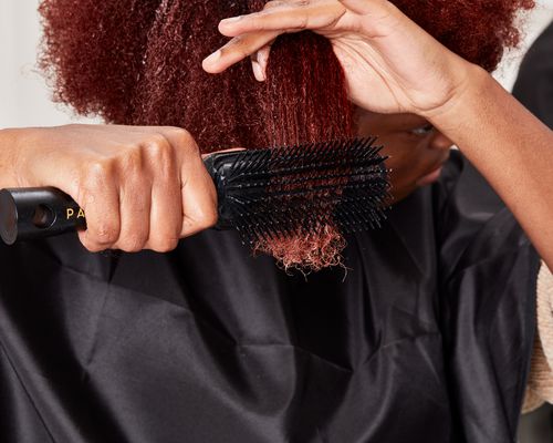 Person brushing hair with Pattern by Tracee Ellis Ross Shower Detangling Brush