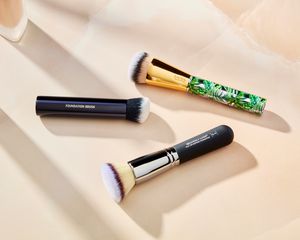 Assortment of the best makeup brushes we recommend on a beige background