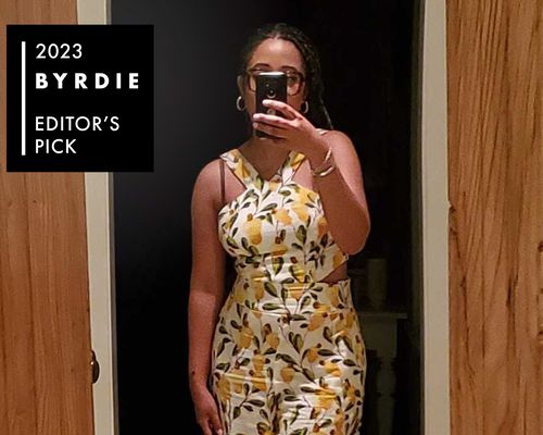 Byrdie editor Eden Stuart wears a yellow and white patterned jumpsuit