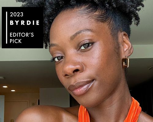 Byrdie editor Jasmine Phillips with a radiant makeup look and curly updo hairstyle