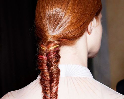 Back of head of woman with red hair in a fishtail braid