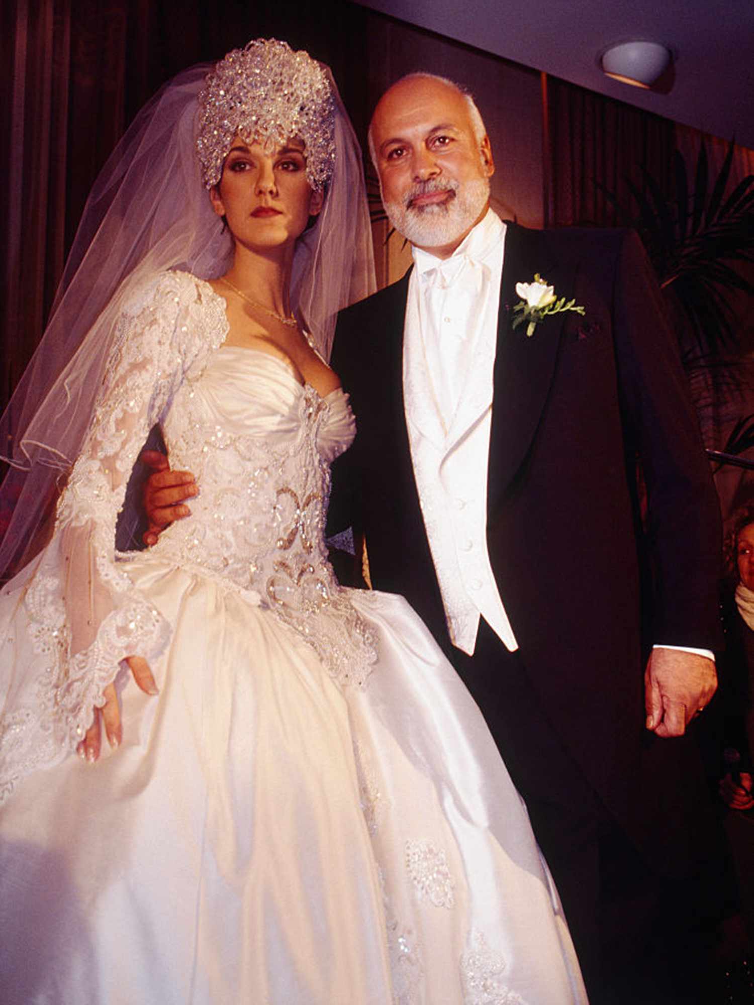 Celine Dion posing with her husband on her wedding day