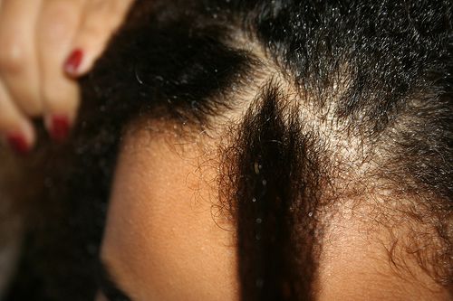 close up of creating a part for cornrow