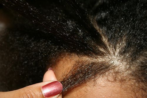 close up of sectioning hair for cornrows