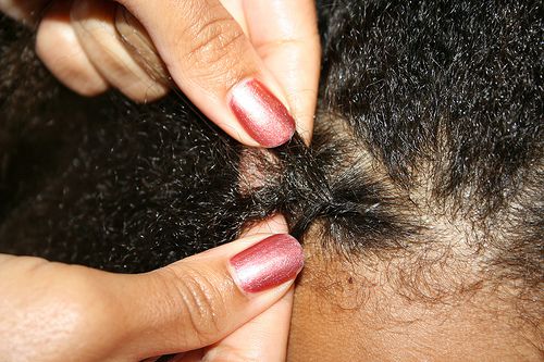 close up of hands braiding a cornrow