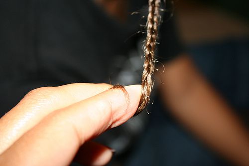 finger looped in small braid