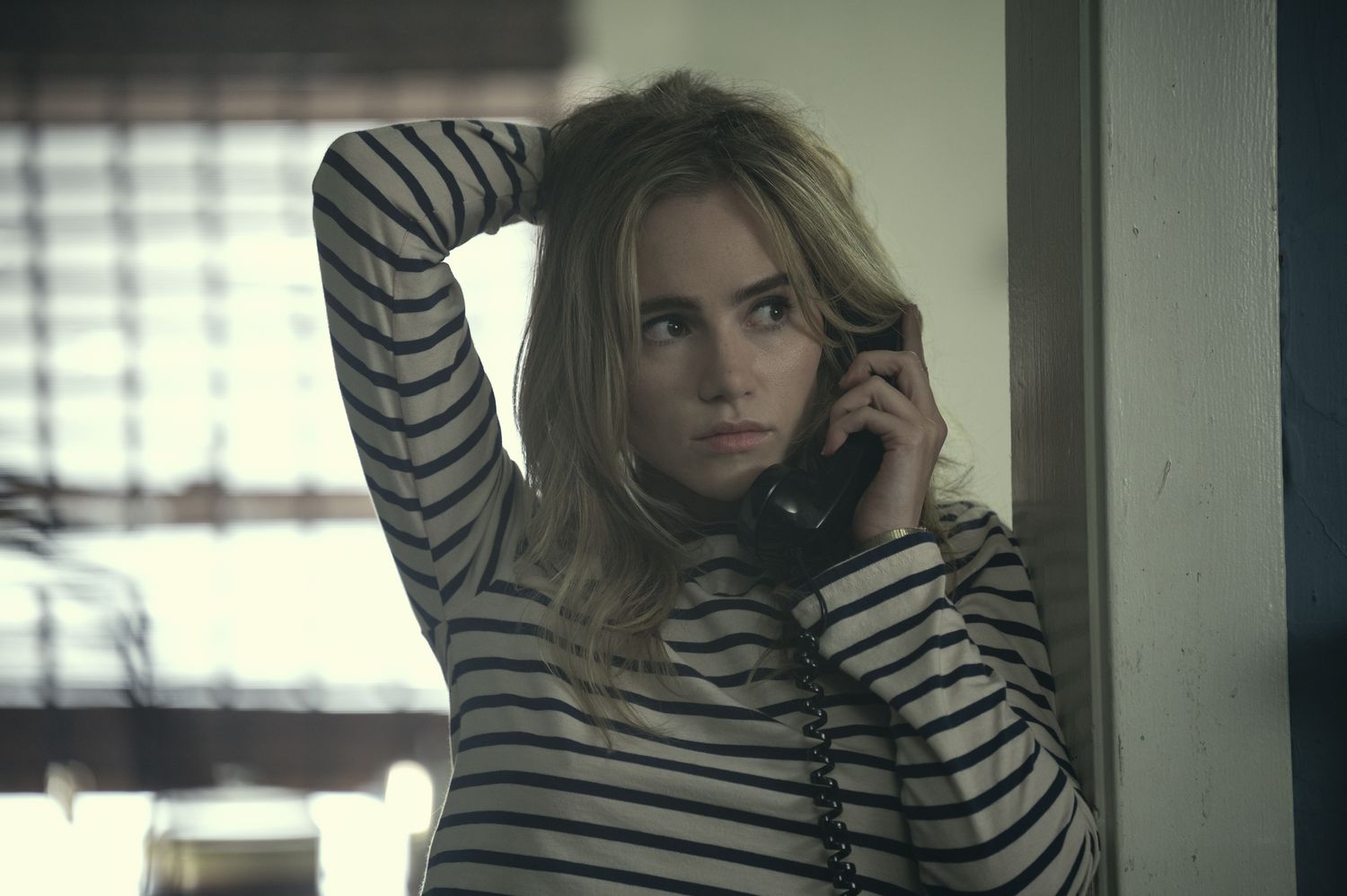 Suki Waterhouse in Daisy Jones and the Six wearing a striped tee