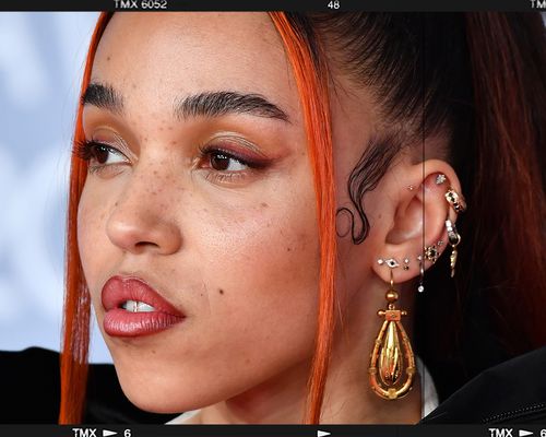 Close up of the singer FKA Twigs with several piercings in her conch