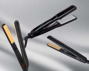 Multiple flat irons arranged on a gray background