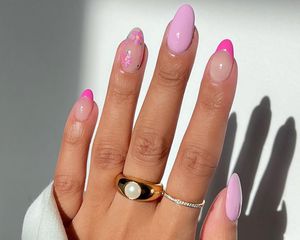 A baby pink French manicure with floral and French tip accents