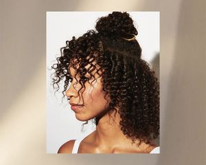 woman with curly hair and a french pin hairstyle