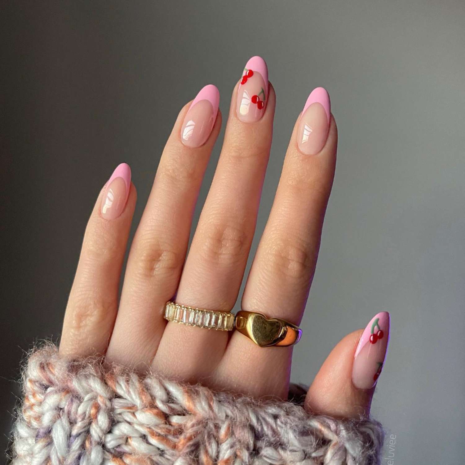 French manicure with pastel pink tips and red cherry designs