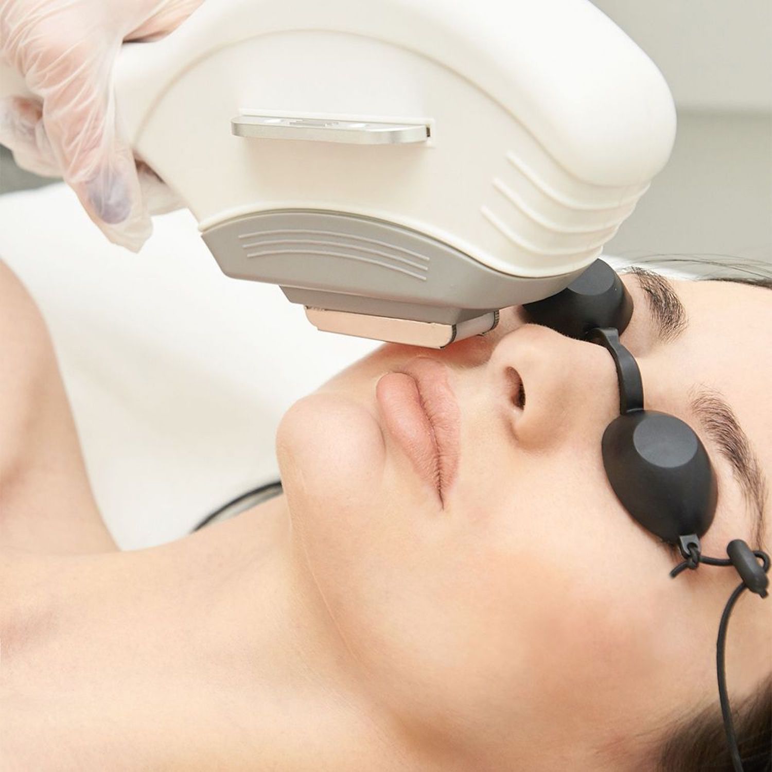 woman wearing goggles getting laser hair removal 