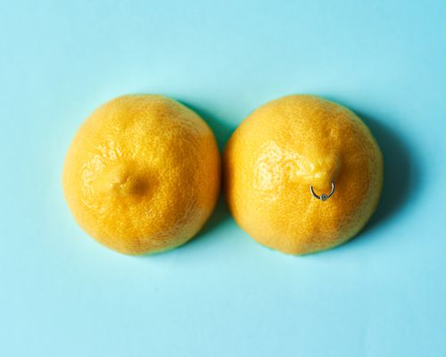 Lemons pierced to look like nipples on a blue background