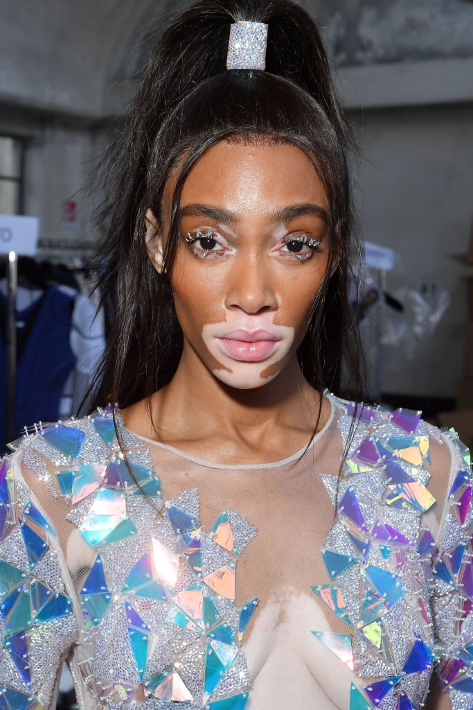 Winnie Harlow sleek half-up, half-down hairdo with sparkly cuff