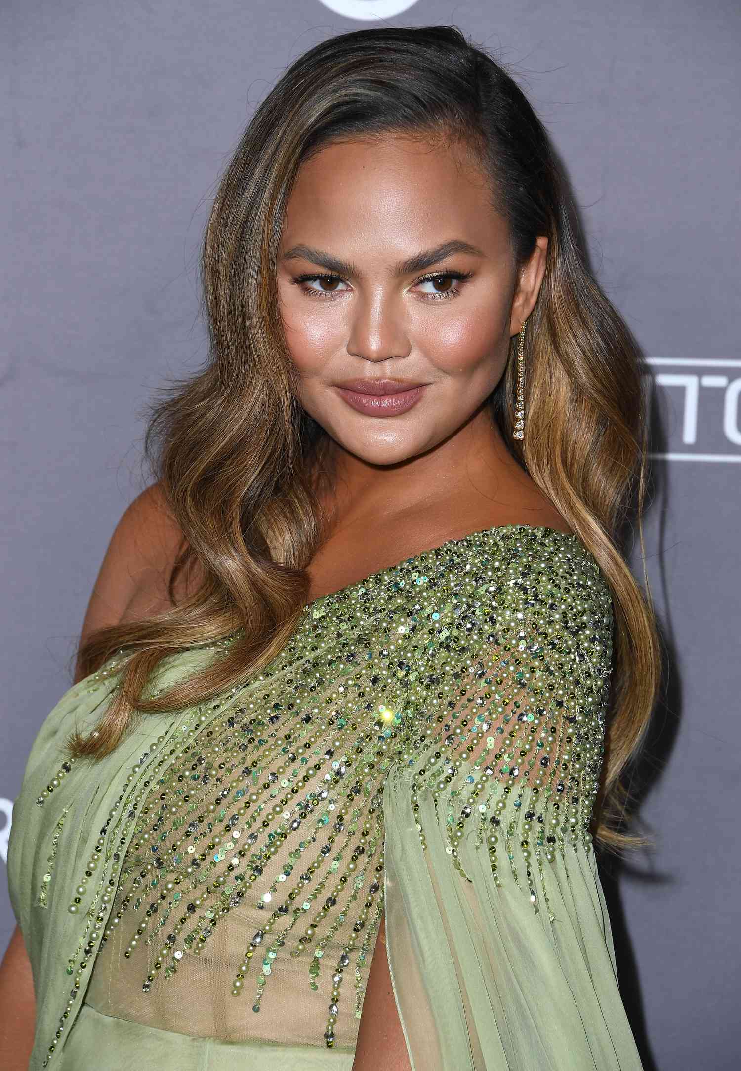 Chrissy Teigen with ombre golden brown hair