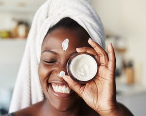 woman smiling with face creme