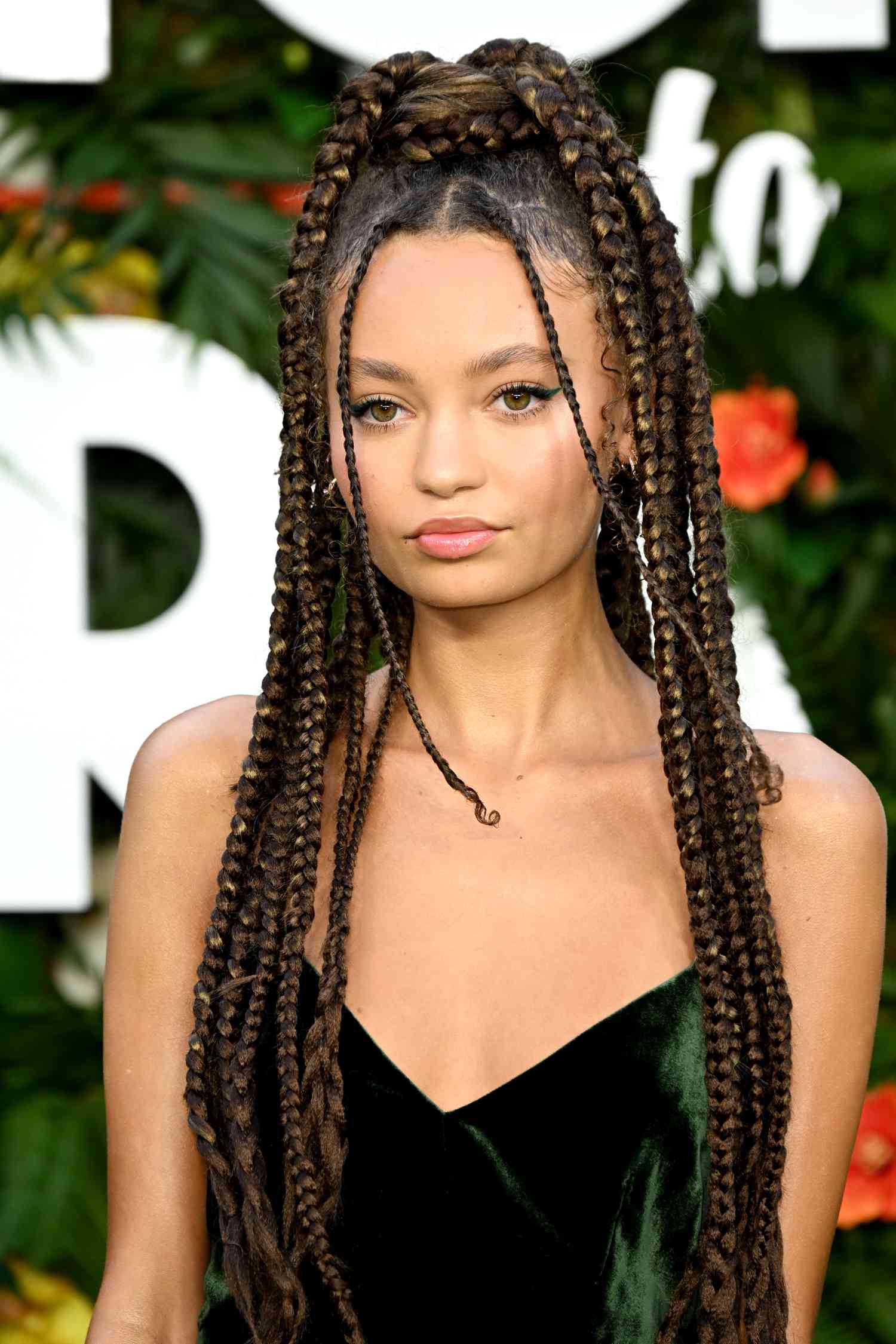 Nico Parker with a braided brown and blonde updo 