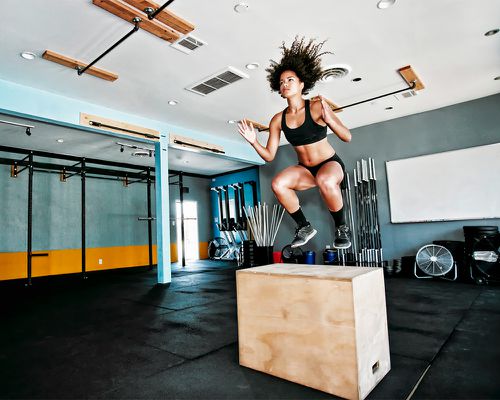 person doing jump squats in gym