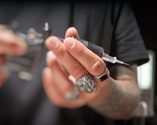 Tattoo gun with needle in it