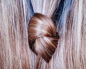 Shiny hair tied in a knot