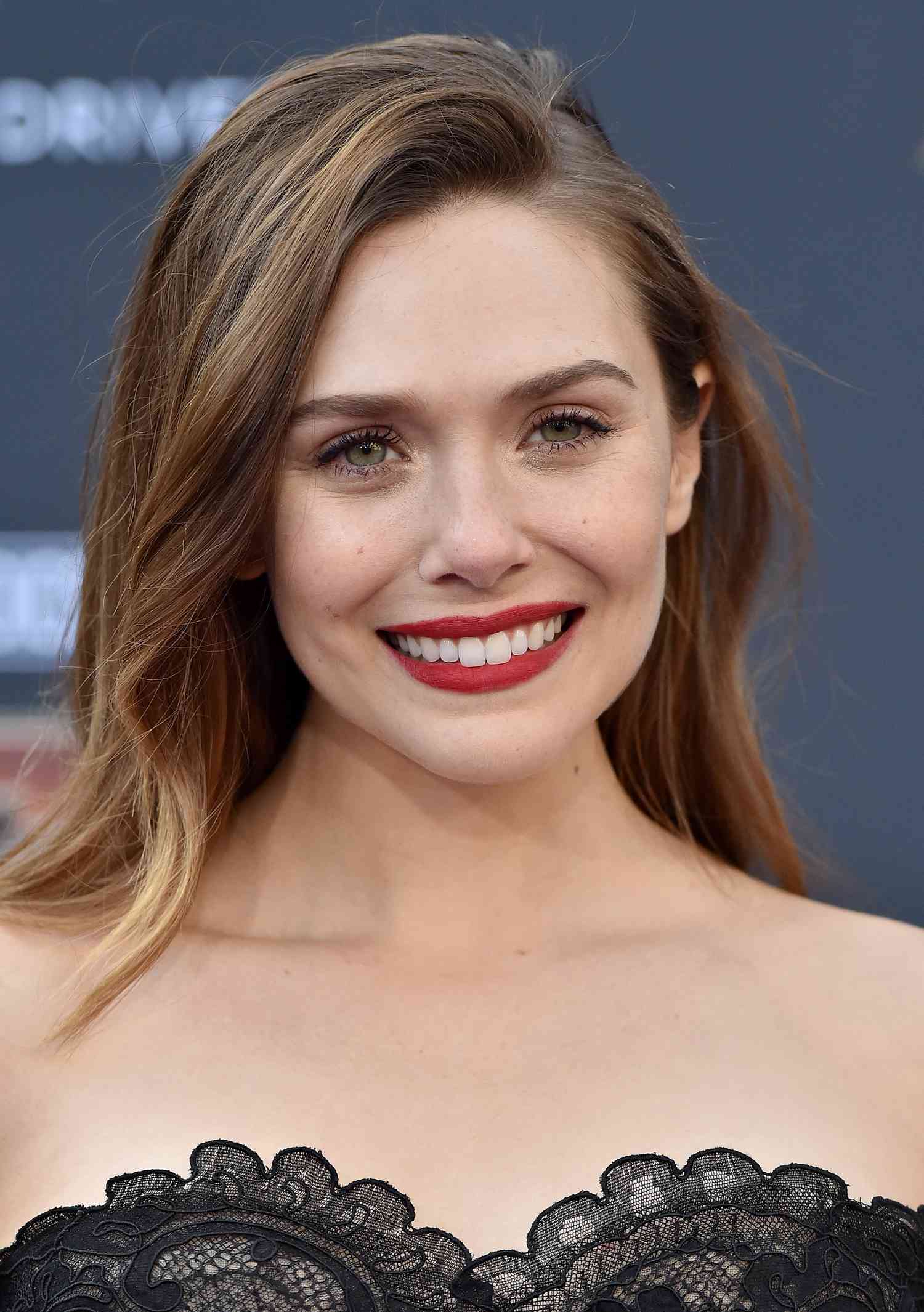 Elizabeth Olsen on the red carpet with light brown hair