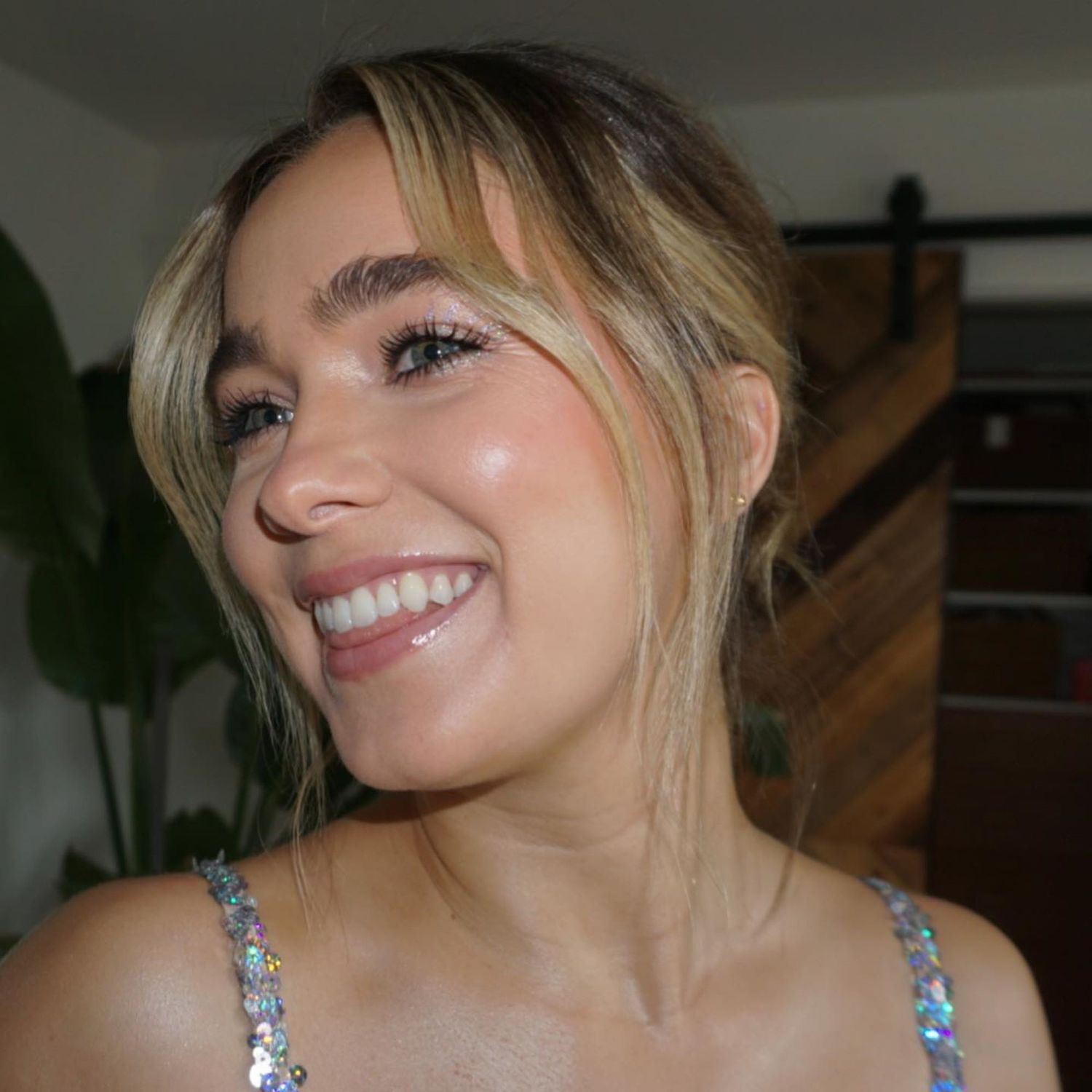 Haley Lu Richardson with sparkly eye makeup and lip gloss