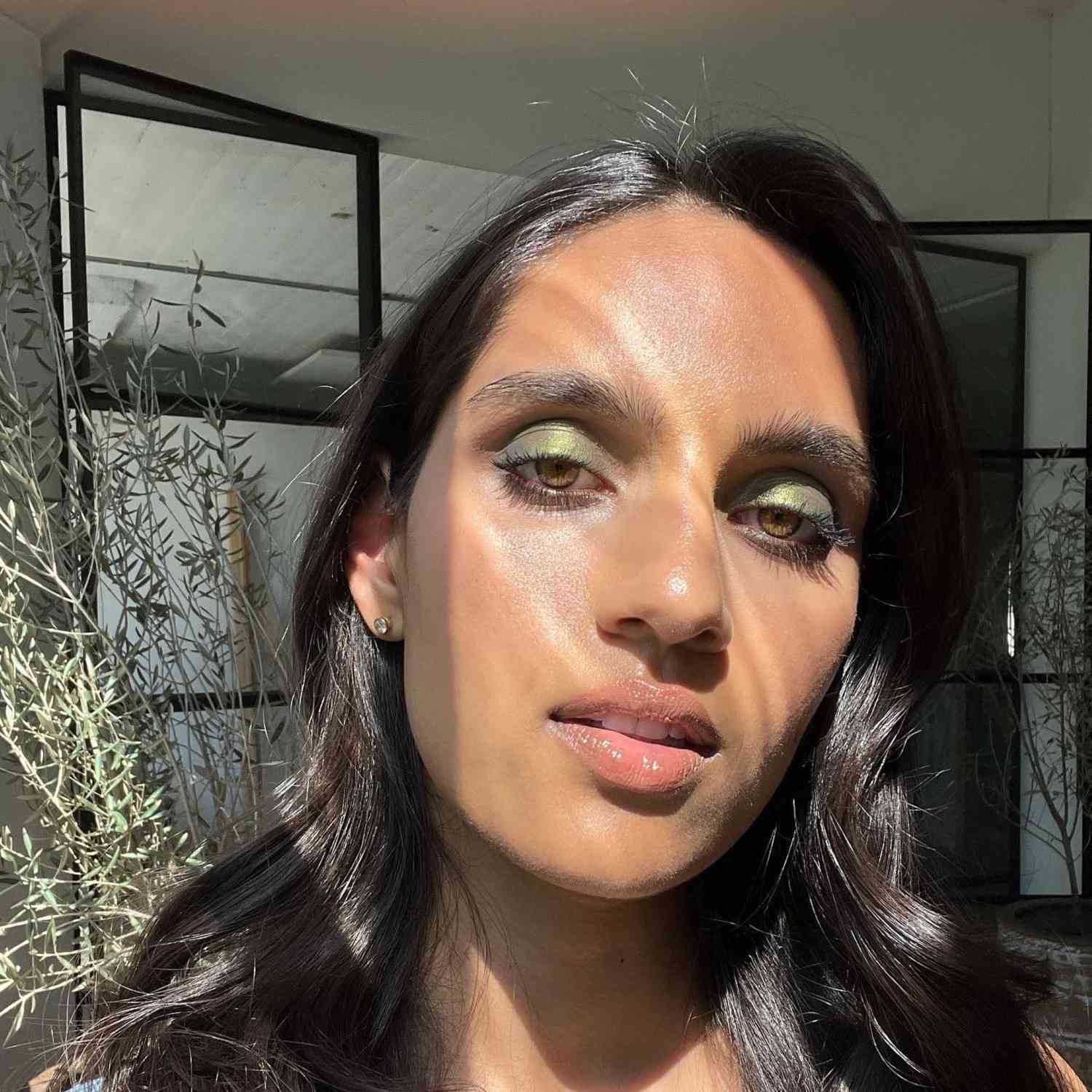 Diya Patel with green eyeshadow and lip gloss