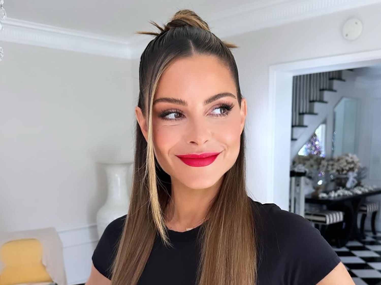 Maria Menounos with a sleek half bun, half down hairstyle