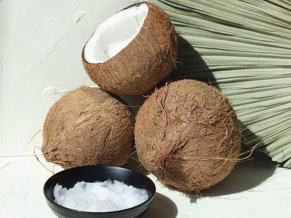 three coconuts on light green background