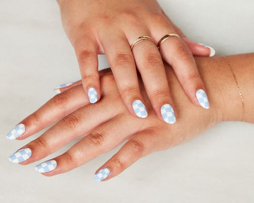 A woman's hands with a press-on manicure