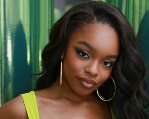 Marsai Martin with gold hoop earrings, lime green dress, and eyeshadow