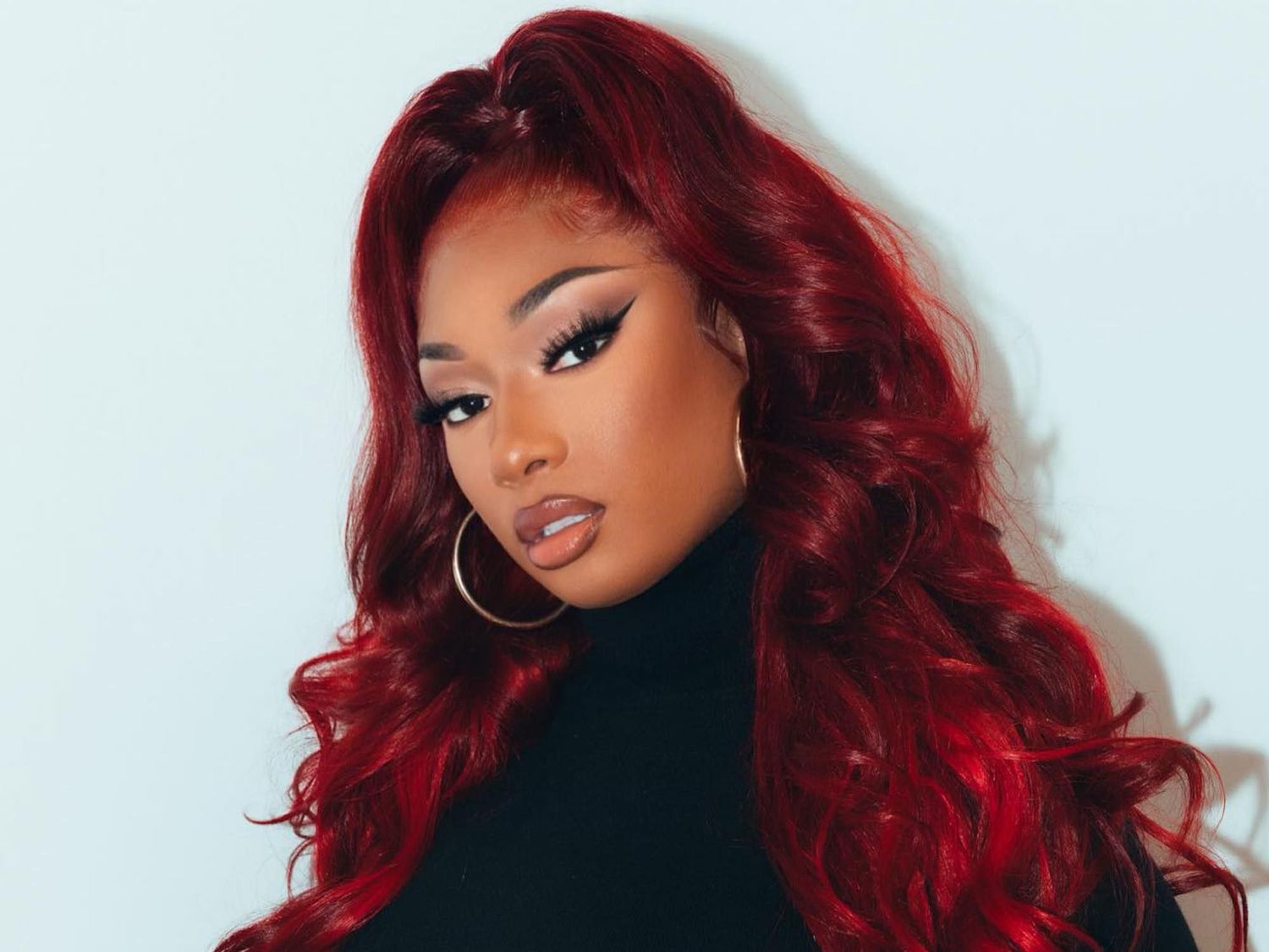 Megan Thee Stallion with cherry coke red hair